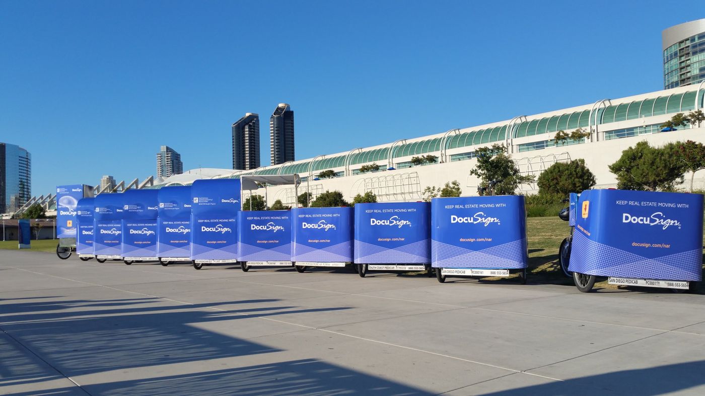 A fleet of branded pedicabs lined up at the Convention Center for an event