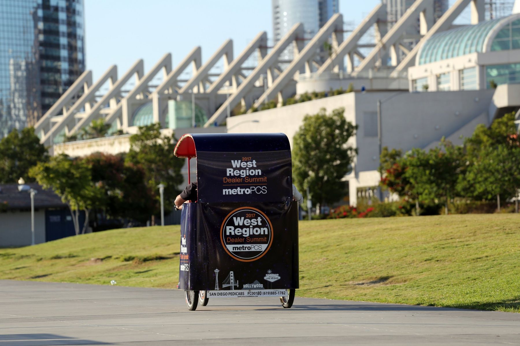 A VIP pedicab riding past the San Diego Convention Center